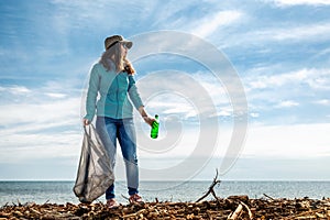 A woman on the eve of the holiday earth Day provides volunteer assistance in cleaning the coastal area of debris. Earth day and