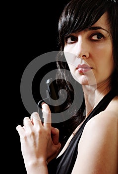 Woman in evening dress holds gun