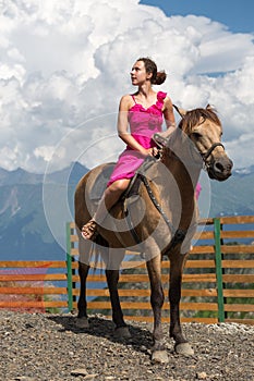 woman in evening dress on horseback in the photo