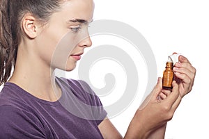 Woman is examine a bottle of homeopathic medicine