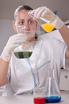 Woman examine colorful bottles fill with chemicals