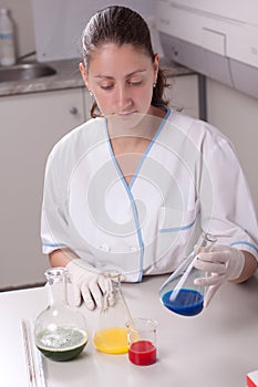 Woman examine colorful bottles fill with chemicals