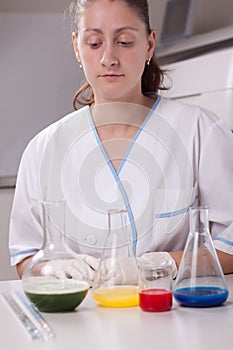 Woman examine colorful bottles fill with chemicals