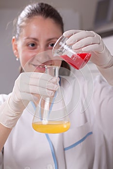 Woman examine colorful bottles fill with chemicals