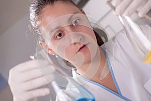 Woman examine colorful bottles fill with chemicals