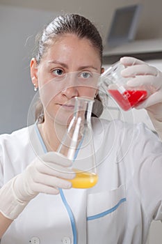 Woman examine colorful bottles fill with chemicals