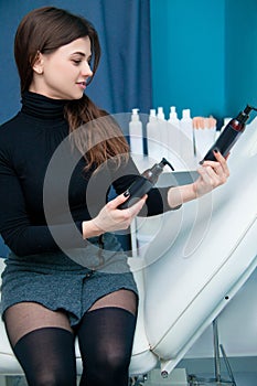 Woman examines cosmetics bottles