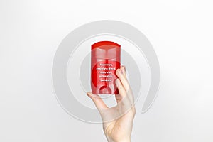 A woman examines the harmful ingredients of the antiperspirant. Stick deodorant with aluminum, propylene glycol, mineral oil, photo