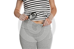 Woman examining genital herpes with magnifying glass on white background, closeup