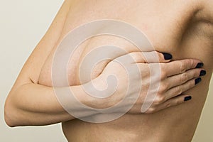 Woman examining her breast