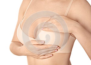 Woman examining her breast on white background, closeup. Cancer awareness concept