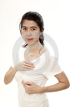 Woman examining herself for breast cancer