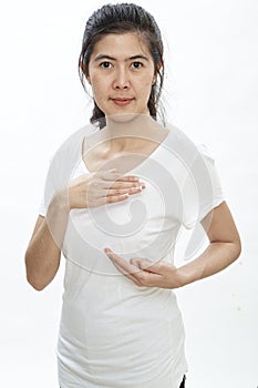 Woman examining herself for breast cancer