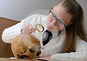 Woman examining a human skull