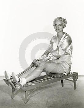 Woman excersing on rowing machine