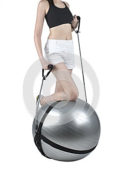 Woman exercise with gym ball and expander