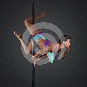 woman exercise pole dance on gray background