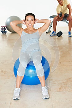 Woman, exercise and portrait for fitness with ball and workout in gym for health and wellness. Cardio, training and