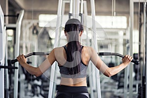 woman exercise by pumping back in gym