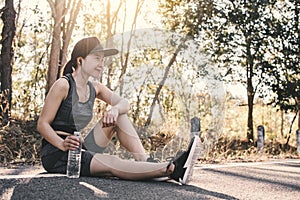 Woman exercise and rest on road