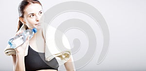 Woman after exercise with water bottle and towel