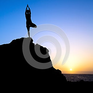 Woman exercise yoga tree sunset silhouette