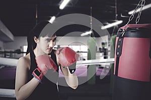 Woman exercises with boxing in the ring