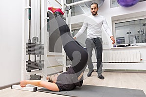 Woman exercising abdominals on cable machine