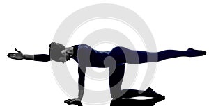 Woman exercising balancing table pose yoga silhouette