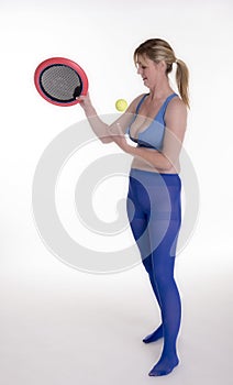 Woman exercising with a bat and ball