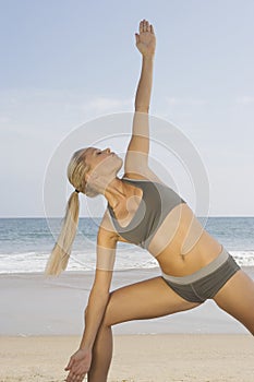 Woman Exercising On Beach