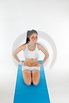 Woman exercising on blue yoga carpet