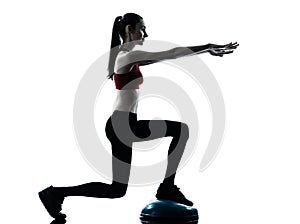 Woman exercising bosu balance ball trainer