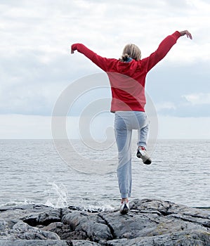Woman exercising on cliff
