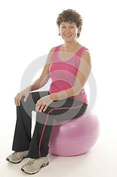 Woman exercising core training fitness ball