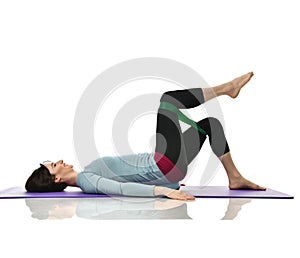 Woman exercising doing postnatal workout. Female fitness instructor working out with a rubber resistance band isolated on white