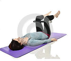 Woman exercising doing postnatal workout. Female fitness instructor working out with a rubber resistance band isolated on white