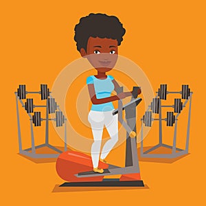 Woman exercising on elliptical trainer.