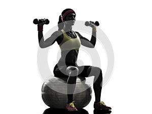 Woman exercising fitness ball weight training silhouette