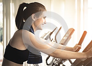 Woman is exercising on a fitness bike machine