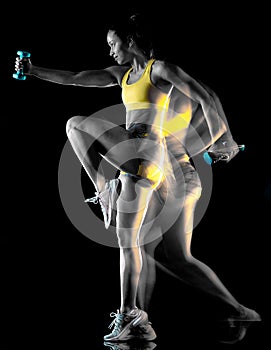Woman exercising fitness exercises isolated black background lightpainting effect