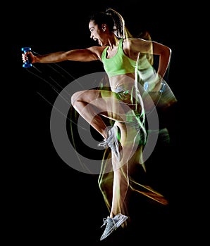 Woman exercising fitness exercises isolated black background lightpainting effect