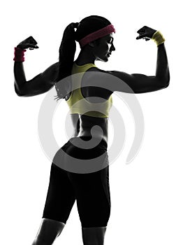 Woman exercising fitness flexing muscles silhouette rear view