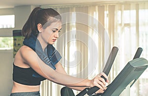 Woman is exercising on a fitness machine