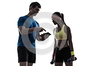 Woman exercising fitness man coach using digital tablet silhoue