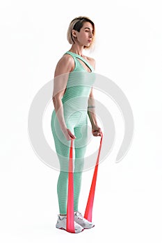 Woman exercising fitness resistance bands in studio silhouette i