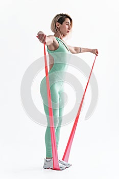 Woman exercising fitness resistance bands in studio silhouette i