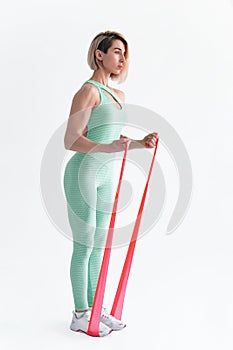 Woman exercising fitness resistance bands in studio silhouette i