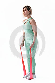 Woman exercising fitness resistance bands in studio silhouette isolated on white background