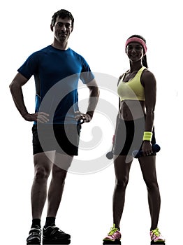 Woman exercising fitness workout with man coach posing